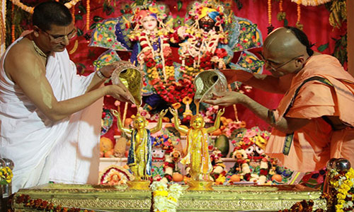 Doing Abhisheka for Krishna